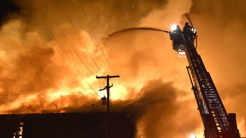 Members of the Springfield Fire Division battle a five alarm fire at Tri-State Pallet in downtown Springfield on Jan. 6, 2015. Bill Lackey/Staff