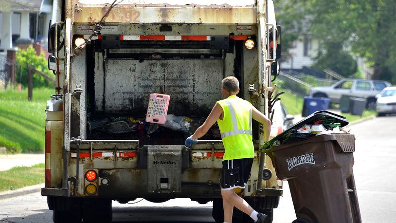 A Rumpke garbage truck picks up trash from a residence in. Bill Lackey/Staff