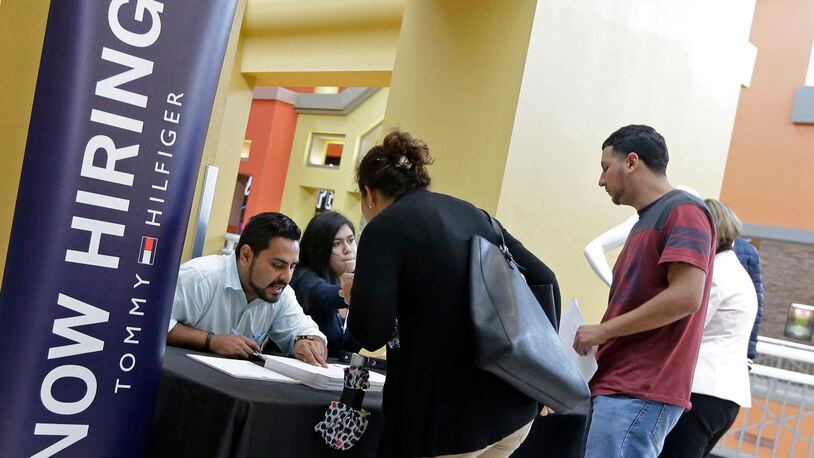 Job seekers check out a job fair in Sweetwater, Fla. in October 2017. AP Photo/Alan Diaz, File