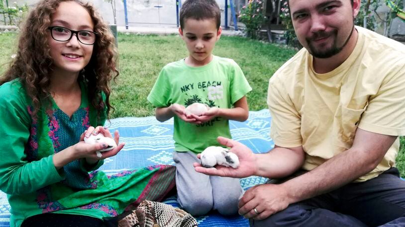 This family photo shows Ryan Corbett holding rabbits with his daughter Miriam and son Caleb in Kabul, Afghanistan in 2020. Lawyers for Corbett, believed held by the Taliban for nearly two years, are asking a United Nations human rights investigator to intervene, citing what they say is cruel and inhumane treatment. Corbett was abducted on August 10, 2022 after returning to Afghanistan, where he and his family had been living at the time of the collapse of the U.S.-based government there one year earlier, on a valid 12-month business visa to pay and train staff. (AP Photo/Anna Corbett)