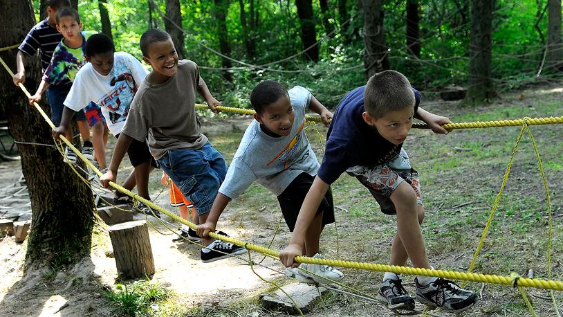 A group of Springfield children walk through an obstacle course at Camp Birch. Staff photo by Marshall Gorby