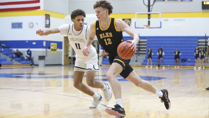 Cutline: Centerville High School junior Tom House drives by Springfield junior Eddie Muhammad during their game on Wednesday night in Springfield. Michael Cooper/CONTRIBUTED