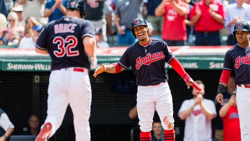 Francisco Lindor waits to celebrate with Jay Bruce (32) of the Cleveland Indians after both scored during the first inning on Bruce's homer at Progressive Field.