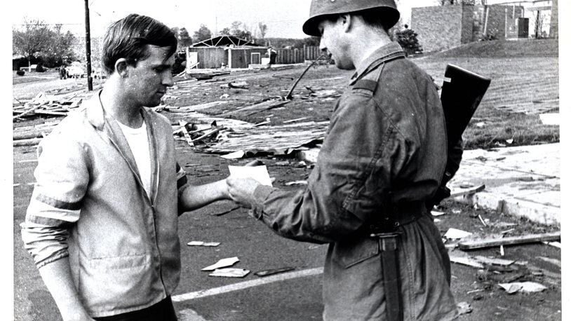 This photo by Photographer Bob Doty from the Dayton Daily News archives ran in the Journal Herald on May 13, 1969. According to the archives, Danny Critchlow is pictured being given a pass by Ohio National Guard Sgt. John Kniffin five days after a powerful tornado struck Kettering and Beavercreek Twp. FILE