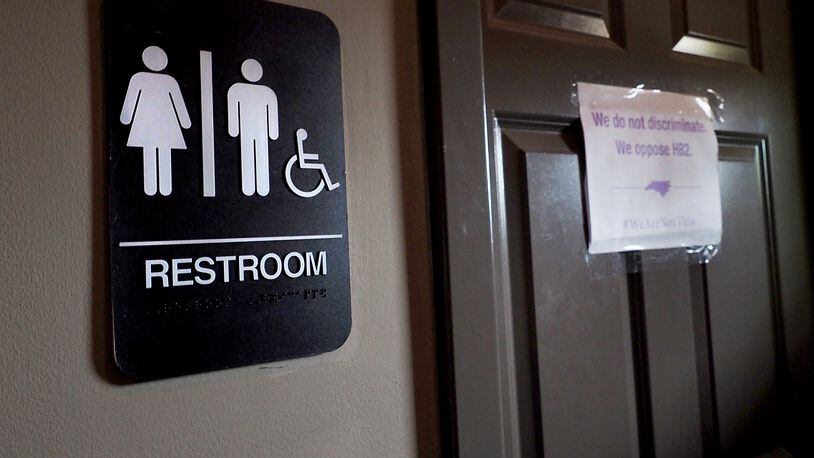 DURHAM, NC - MAY 10: A unisex sign and the 'We Are Not This' slogan are outside a bathroom at Bull McCabes Irish Pub on May 10, 2016 in Durham, North Carolina. Debate over transgender bathroom access spreads nationwide as the U.S. Department of Justice countersues North Carolina Governor Pat McCrory from enforcing the provisions of House Bill 2 that dictate what bathrooms transgender individuals can use. (Photo by Sara D. Davis/Getty Images)