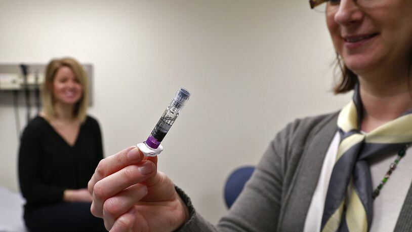 Kristen Earley, an RN at the Clark County Combined Heath District, gets a preloaded flu shot ready last month. Clark County has seen 42 hospitalizations from the flu since the first of the year. Bill Lackey/Staff