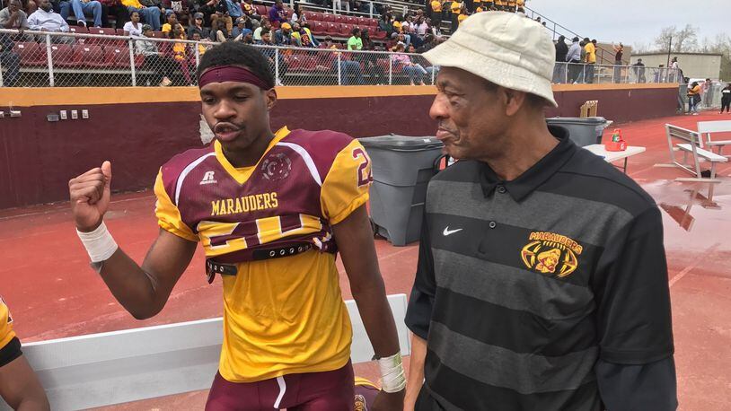 Former NFL player and veteran college coach George Ragsdale (left), who is now Central State s wide receivers coach, on sideline with Marauders Devon Cunningham during Saturday s annual Spring Showcase at McPherson Stadium. Tom Archdeacon/STAFF