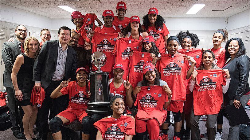 The Ohio State women's basketball team poses in the locker room with the Big Ten championship trophy. (Photo courtesy Ohio State Athletics Communications)
