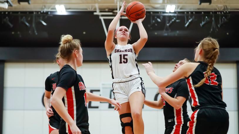 Greenon High School senior Abby West shoots a jumper over several defenders during their game against Tecumseh earlier this season. West recently surpassed 1,000 career points. Michael Cooper/CONTRIBUTED