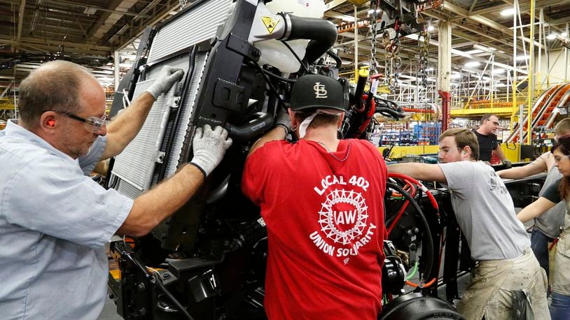 In this file photo, workers assemble a truck on the assembly line at Navistar in 2017. The company was acquired by a subsidiary of Volkswagen in 2021. Bill Lackey/Staff