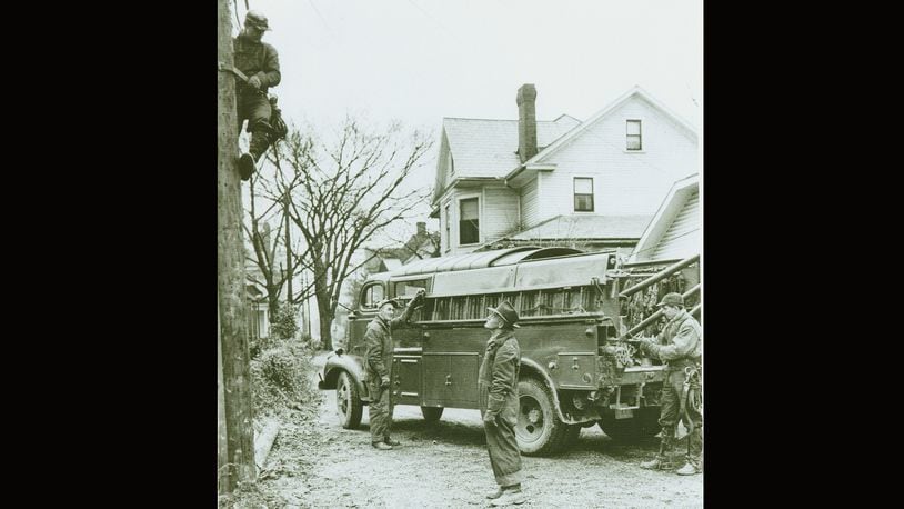 This photo from the mid-1950s shows Ohio Edison linemen working on a job in Springfield. In the 1940s and 1950s residential electrification was expanding greatly and there was improvement in safety standards and an increase in job opportunities to meet the demands. On the pole is Roger Burk Jr. and left to right is Bill Ringer, Foreman Keith Wheeler, and Tony Spencer. PHOTO COURTESY OF THE CLARK COUNTY HISTORICAL SOCIETY
