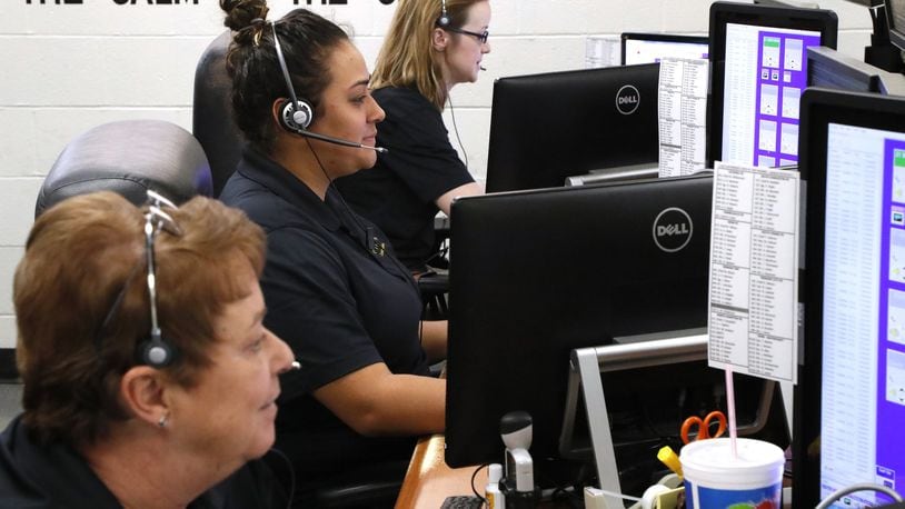 Three of the dispatchers in the Clark County Dispatch Center answer emergency calls. Bill Lackey/Staff