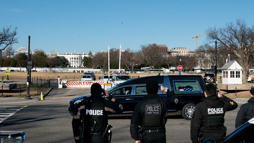 The hearse carrying the body of Brian Sicknick, the U.S. Capitol police officer who died as a result of injuries from an attack on the complex, passes in front of the White House in Washington, Jan. 10, 2021. Democrats plan to charge President Donald Trump with high crimes and misdemeanors for his role inciting a mob at the Capitol. (Erin Scott/The New York Times)