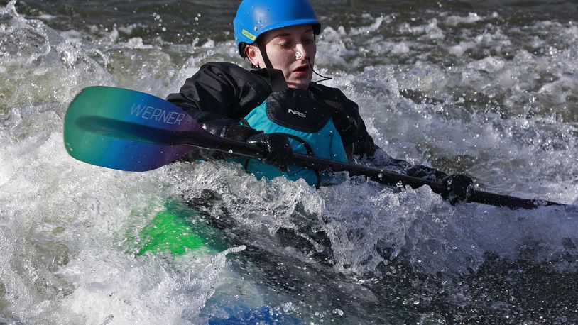 Trisha Garrettson surfs the rapids in a kayak Tuesday, Jan. 17, 2023 as she takes advantage of the sunshine at the white water feature in Snyder Park. BILL LACKEY/STAFF