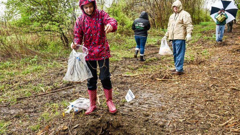 Addison Lanich, 12, was one of the volunteers planting one hundred trees at Riverside Natural Area Tuesday, April 24 in Hamilton. NICK GRAHAM/STAFF