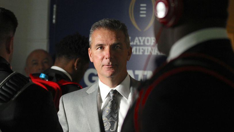 Ohio State’s Urban Meyer greets players as they enter the locker room after arriving at the Fiesta Bowl on Dec. 31, 2016, at University of Phoenix Stadium in Glendale, Ariz. David Jablonski/Staff