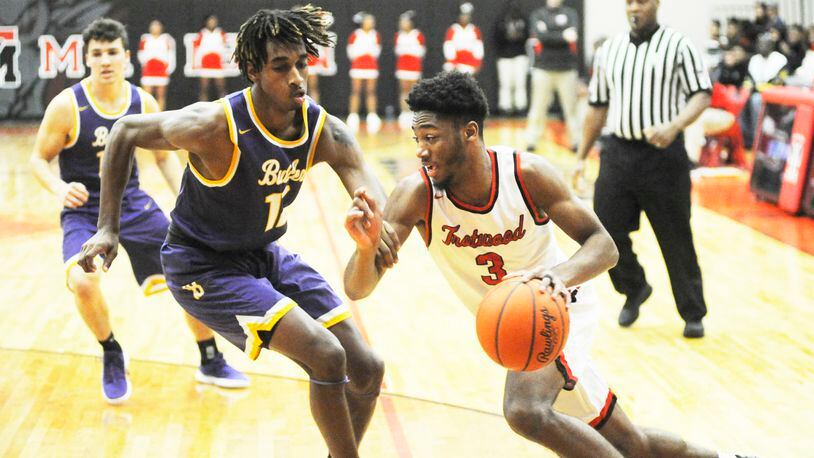 Sammy Anderson of Trotwood-Madison (with ball) drives. MARC PENDLETON / STAFF