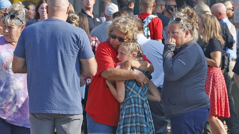 Family members are reunited with their children at the German Township Government Center following a Northwestern School District bus crash on State Route 41 in Springfield, Ohio, Tuesday, Aug. 22, 2023. (Bill Lackey/The Springfield News-Sun via AP)