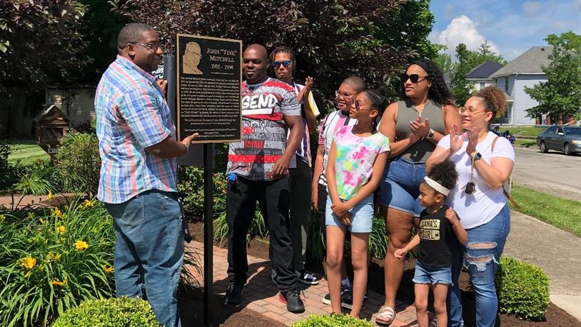 Family members of the late John "Tink" Mitchell unveil a plaque at a dedication ceremony opening Tink Memorial Park on Linden Ave. in Springfield on Saturday.