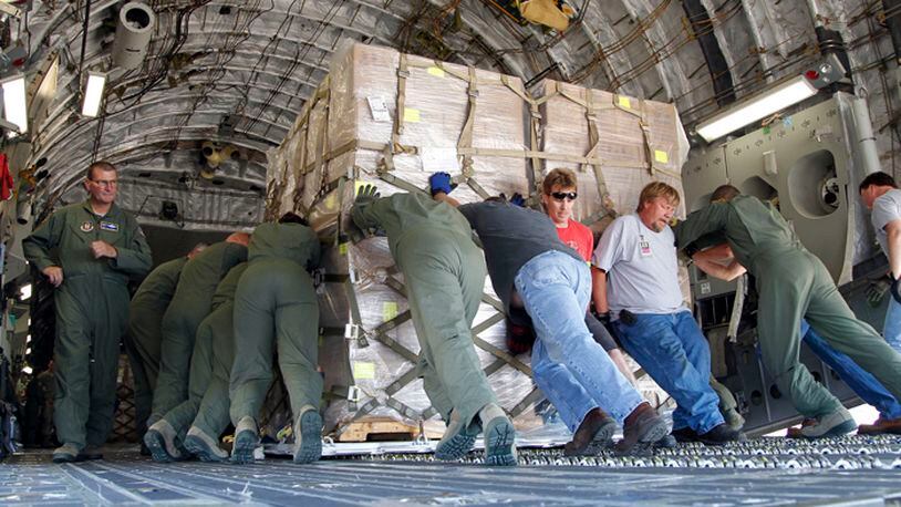 The 445th Airlift Wing at Wright-Patterson Air Force Base loaded more than half-a-million prepackaged meals onto a C-17 bound for Haiti on Friday, June 14. Loadmasters pushed the giant cargo palets of food onto the jet. TY GREENLEES / STAFF