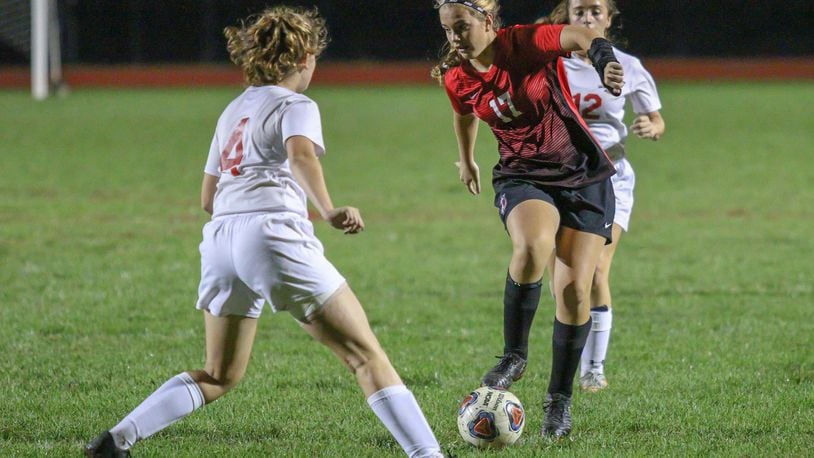 Tecumseh High School sophomore Bridget Harris dribbles the ball through the defense during the Arrows 3-1 victory over the Lakers on Wednesday, Oct. 10 at Spitzer Stadium in New Carlisle. Michael Cooper/CONTRIBUTED