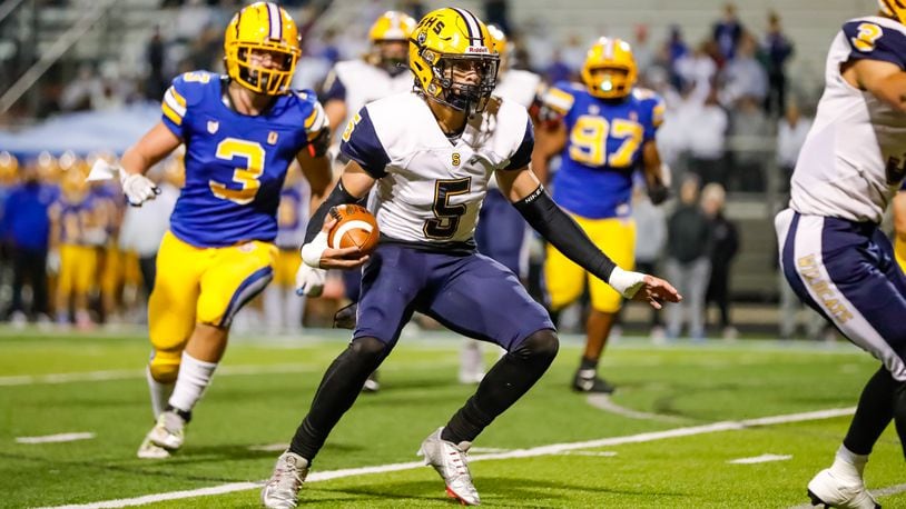 Springfield High School senior Aaron Scott runs the ball during their playoff game against Olentangy earlier this season. Michael Cooper/CONTRIBUTED