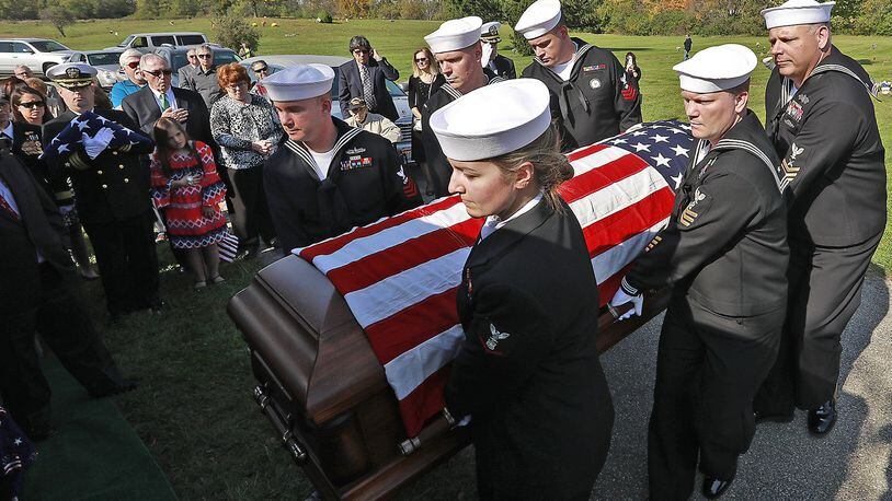 Members of a Navy honor guard carry the remains of William “Billy” Welch to the grave site at Calvary Cemetery Saturday. Welch was killed 75 years ago during the bombing of Pearl Harbor and his remains were just recently identified. Welch, who attended Catholic Central High School, was buried with full military honors Saturday. Bill Lackey was nominated for an Ohio APME award for this photo. Bill Lackey/Staff