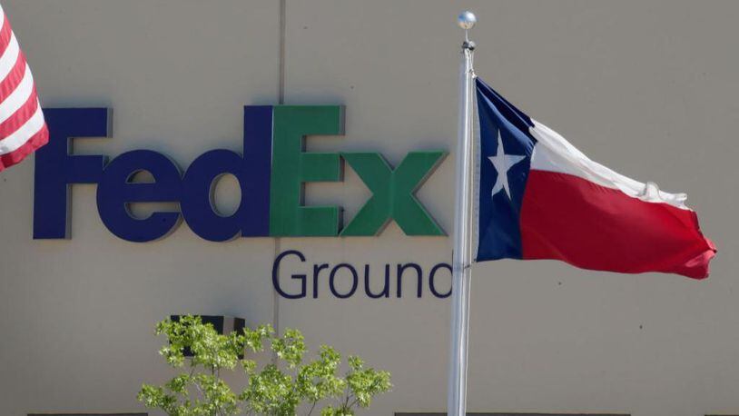 A Texas state flag flies outside a FedEx facility following an explosion on March 20, 2018 in Schertz, Texas. A package exploded while being transported on a conveyor shortly after midnight.