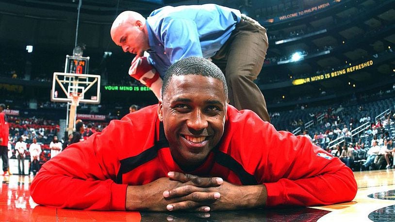 Lorenzen Wright, #42 of the Atlanta Hawks, stretches with help from strength coach Chattin Hill before a game against the Boston Celtics at Philips Arena January 15, 2007 in Atlanta, Georgia.