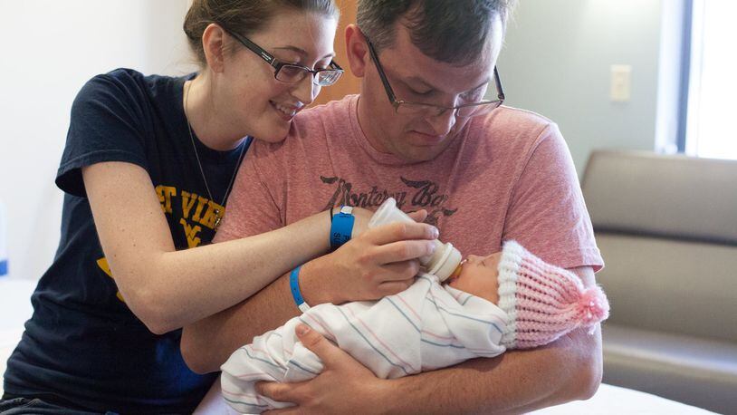 A couple meets their adopted newborn for the first time at Choosing Hope Adoptions. Contributed.