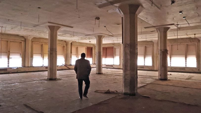 John Landess, executive director of the Turner Foundation, walks through one of the upper floors of the Wren Building in downtown Springfield. The plan is to turn the historic building into 89 apartment units as well as create commercial space. BILL LACKEY/STAFF