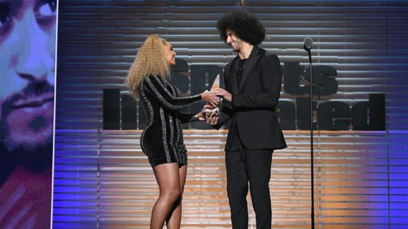 NEW YORK, NY - DECEMBER 05:  Colin Kaepernick receives the SI Muhammad Ali Legacy Award with Beyonce and Trevor Noah during SPORTS ILLUSTRATED 2017 Sportsperson of the Year Show on December 5, 2017 at Barclays Center in New York City.  (Photo by Slaven Vlasic/Getty Images for Sports Illustrated)