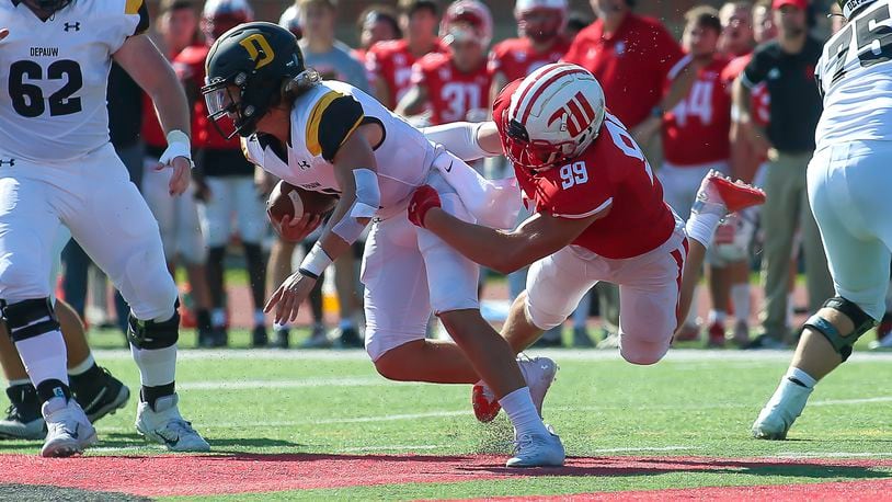 Wittenberg University's Conner Walls grabs DePauw University quarterback Chase Andries during their game on Sturday on Saturday afternoon at Edwards-Maurer Field in Springfield. DePauw won 17-14. CONTRIBUTED PHOTO BY MICHAEL COOPER