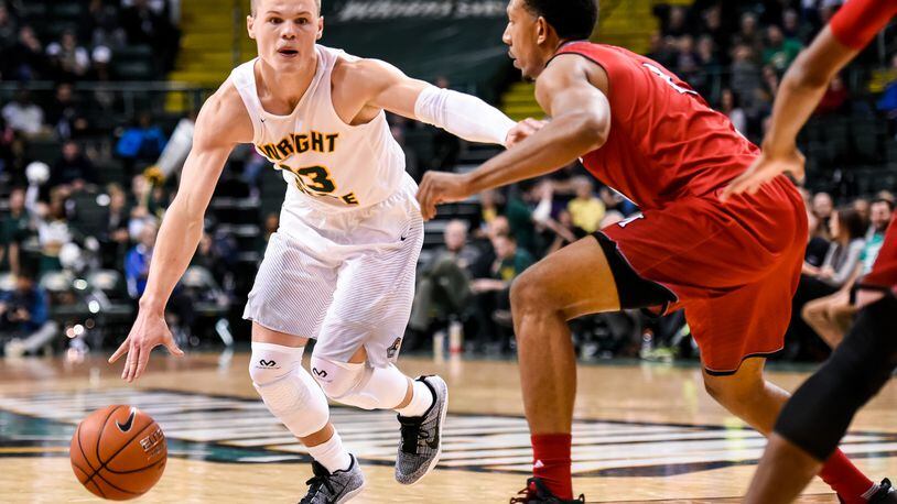 Wright State University’s Grant Benzinger dribbles to the hoop defended by Miami University’s Rod Mills, Jr. during their 89-87 win over Miami Tuesday, Nov. 15 at Wright State University’s Nutter Center in Fairborn. NICK GRAHAM/STAFF