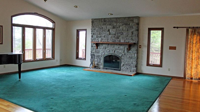 Features of the great room include hardwood floors, a floor-to-ceiling, stone fireplace and vaulted ceilings.