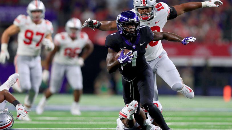 ARLINGTON, TX - SEPTEMBER 15: Jalen Reagor #1 of the TCU Horned Frogs carries the ball against Damon Arnette Jr #3 of the Ohio State Buckeyes and Jonathon Cooper #18 of the Ohio State Buckeyes in the first quarter during The AdvoCare Showdown at AT&T Stadium on September 15, 2018 in Arlington, Texas. (Photo by Tom Pennington/Getty Images)