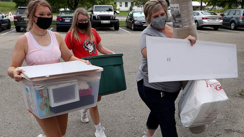 Wittenberg freshman Chloe Jordan, left, gets a hand moving into Tower Hall from her sister, Abbey, and mother, Melanie, Wednesday. BILL LACKEY/STAFF