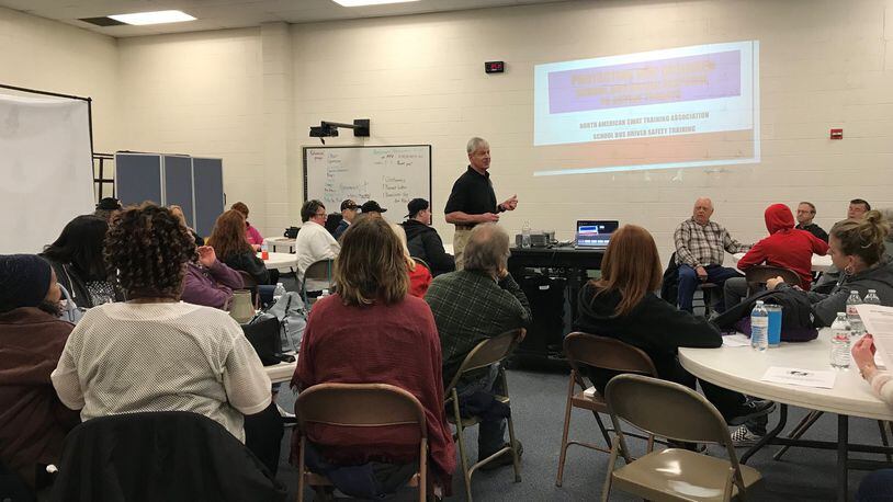 James Scanlon, co-owner of North American SWAT Training Association, trains Fairborn City Schools bus drivers. KAYLA COURVELL/STAFF