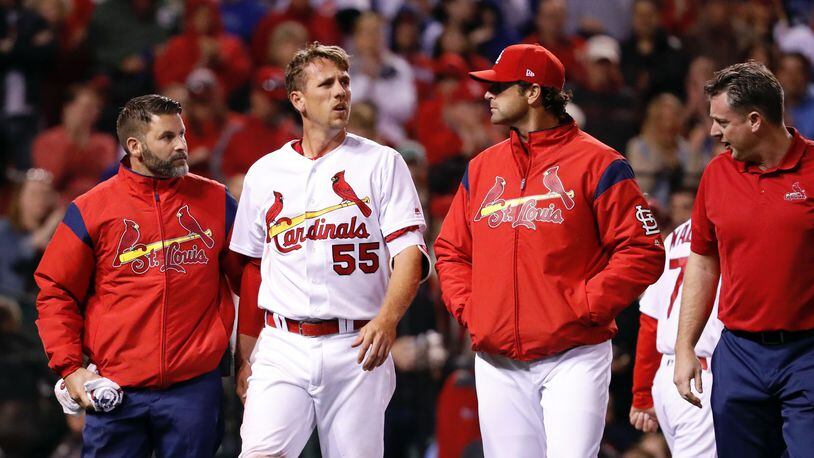 The Cardinals' Stephen Piscotty (55) walks off the field after being injured while scoring during the fifth inning against the Chicago Cubs on Tuesday, April 4, 2017, in St. Louis. (AP Photo/Jeff Roberson)