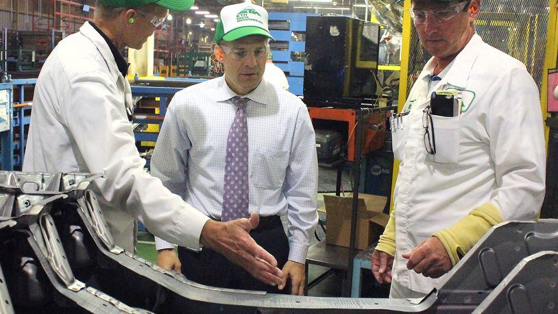 U.S. Rep. Jim Jordan, R-Urbana (center) listens as KTH Parts Industries vice president, Chris Millice (left) and senior vice president, Rob Hayes explains some of the parts the company makes. JEFF GUERINI/STAFF
