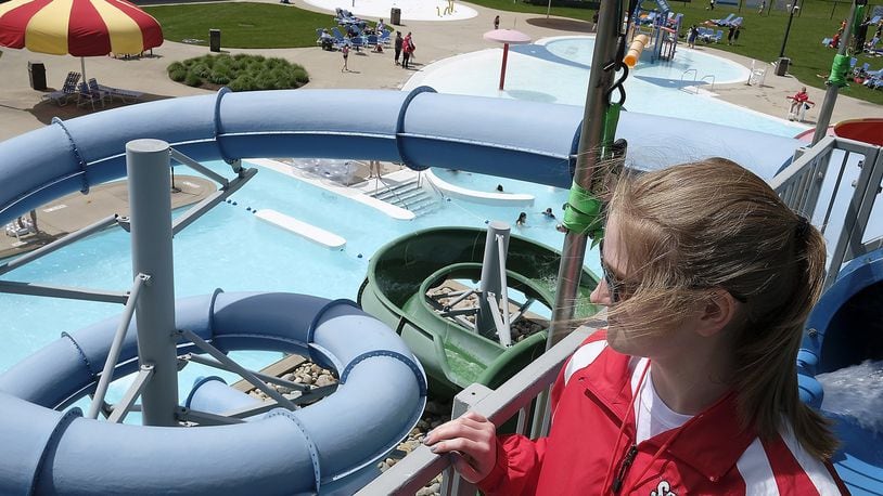Elizabeth Brown, a life guard at Splash Zone in Springfield, looks out of the pool as she waits for someone to go down the water slides Monday. Bill Lackey/Staff