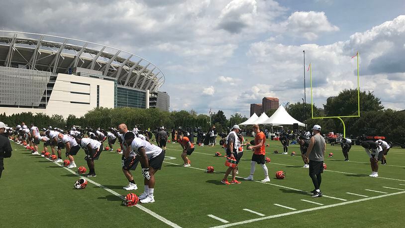 Wearing shoulder pads for the first time in training camp, Cincinnati Bengals players stretch prior to practice Saturday. JAY MORRISON/STAFF