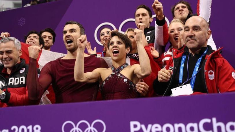 Pairs figure skater Meagan Duhamel, center, and her partner, Eric Radford, of Canada react to their score after competing in the Figure Skating Team Event Pairs Free Skating on day two of the PyeongChang 2018 Winter Olympic Games at Gangneung Ice Arena on February 11, 2018 in Gangneung, South Korea. Their performance helped secure the gold for their team.