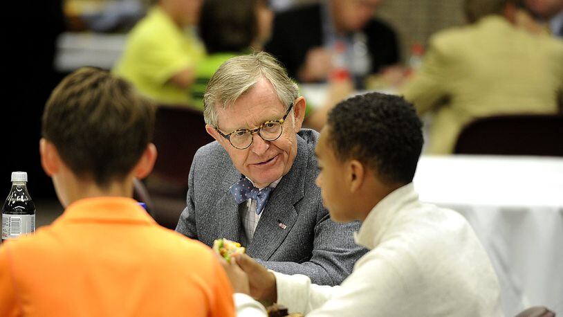 Former Ohio State University President E. Gordon Gee talks to students at the new Global Impact STEM Academy in Springfield on Wednesday over lunch. Gee and Sen. Chris Widener were on hand for a $5,000 check presentation from DuPont Pioneer. Bill Lackey/Staff
