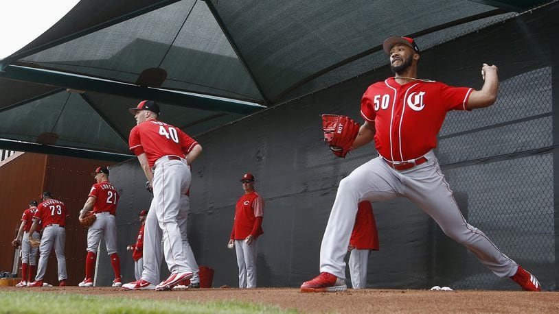 Cincinnati Reds pitchers Amir Garrett (50), Alex Wood (40), Michael Lorenzen (21) and Odrisamer Despaigne (73) join others as they pitch during workouts at the Reds spring training baseball facility, Wednesday, Feb. 13, 2019, in Goodyear, Ariz. (AP Photo/Ross D. Franklin)