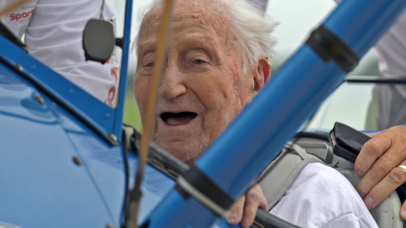 World War II veteran Ed Fisher, who recently turned 100 years-old, smiles after taking a Dream Flight in a restored Boeing Stearman biplane at Grimes Field in Urbana. Ed was a NAVY pilot and actually trained in a Stearman biplane.  BILL LACKEY/STAFF