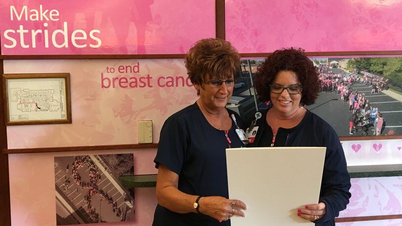 Tracy Adrian (right) Springfield Regional Cancer Center’s Breast Health Navigator, goes over plans for Breast Cancer Awareness Month with the center’s Teresa Hawke. CONTRIBUTED PHOTO BY BRETT TURNER
