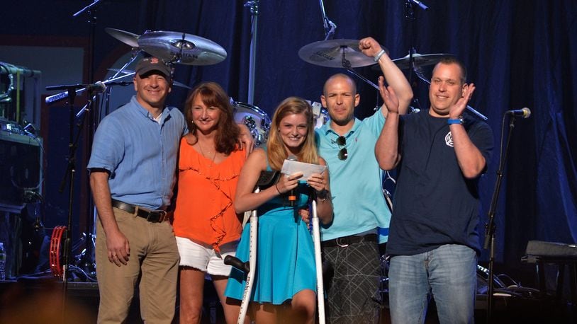 BOSTON, MA - MAY 30: Marathon bystander Bruce Mendhelson, first responder Alicia Shambo, Marathon victim Victoria McGrath, first responder Tyler Dodd, and Boston firefighter Jimmy Plourde on stage during the Boston Strong: An Evening Of Support And Celebration at TD Garden on May 30, 2013 in Boston, Massachusetts. (Photo by Paul Marotta/Getty Images)