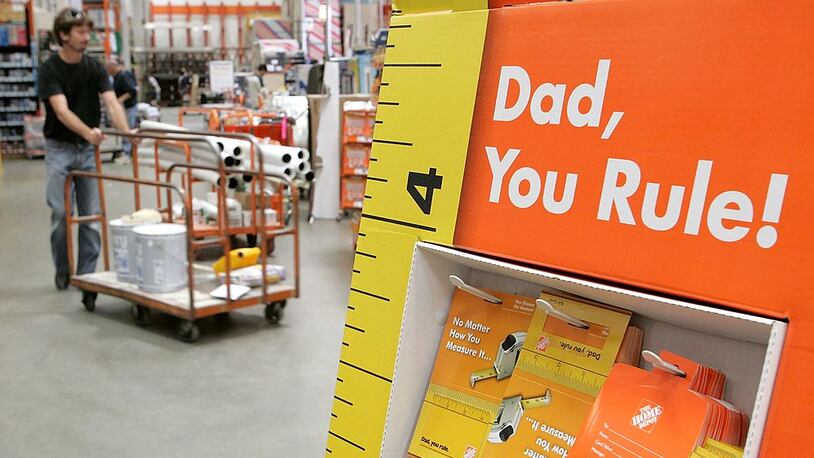 SAN RAFAEL, CA - JUNE 15: A Home Depot customer walks by a display of Father's Day gift cards at a Home Depot store on June 15, 2006 in San Rafael, California. Retail outlets are promoting Father's day gift buying in hopes that the holiday will become more profitable for businesses. (Photo by Justin Sullivan/Getty Images)