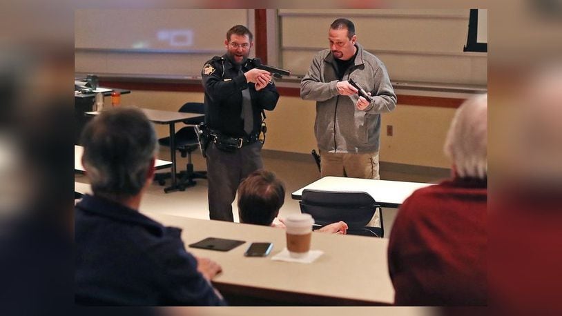 Clark County Sheriff’s deputy Scott Cultice and Dave Lyle, coordinator of safety and security at Springfield City School, demonstrate a situation during an Active Threat Respose Class at Wittenberg University Thursday. Bill Lackey/Staff